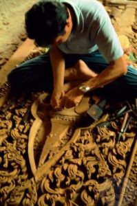 carving wood doors for temple in Thailand