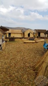 reed islands with thatched huts on titicaca lake